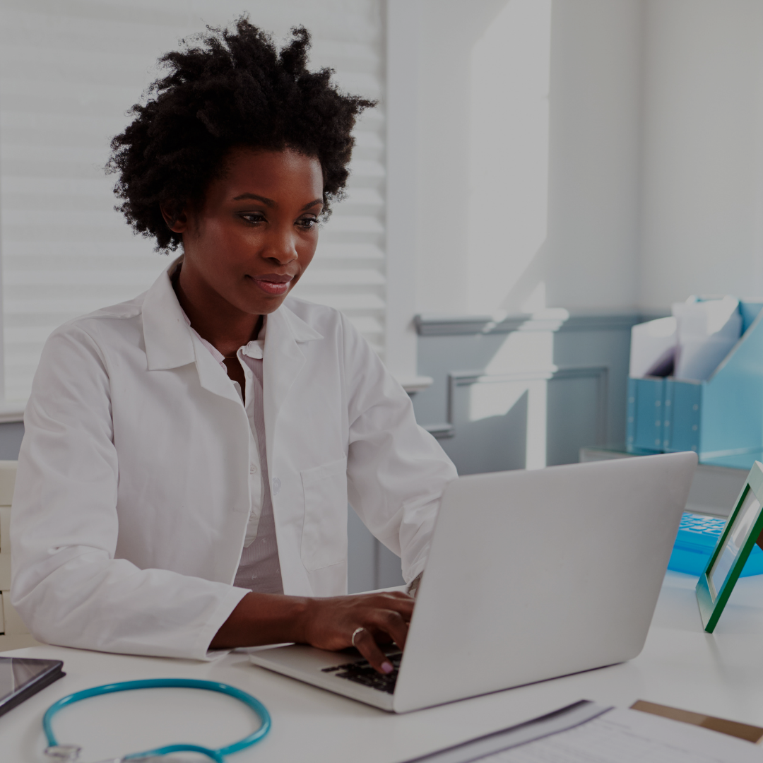 Image of Black female doctor on her computer