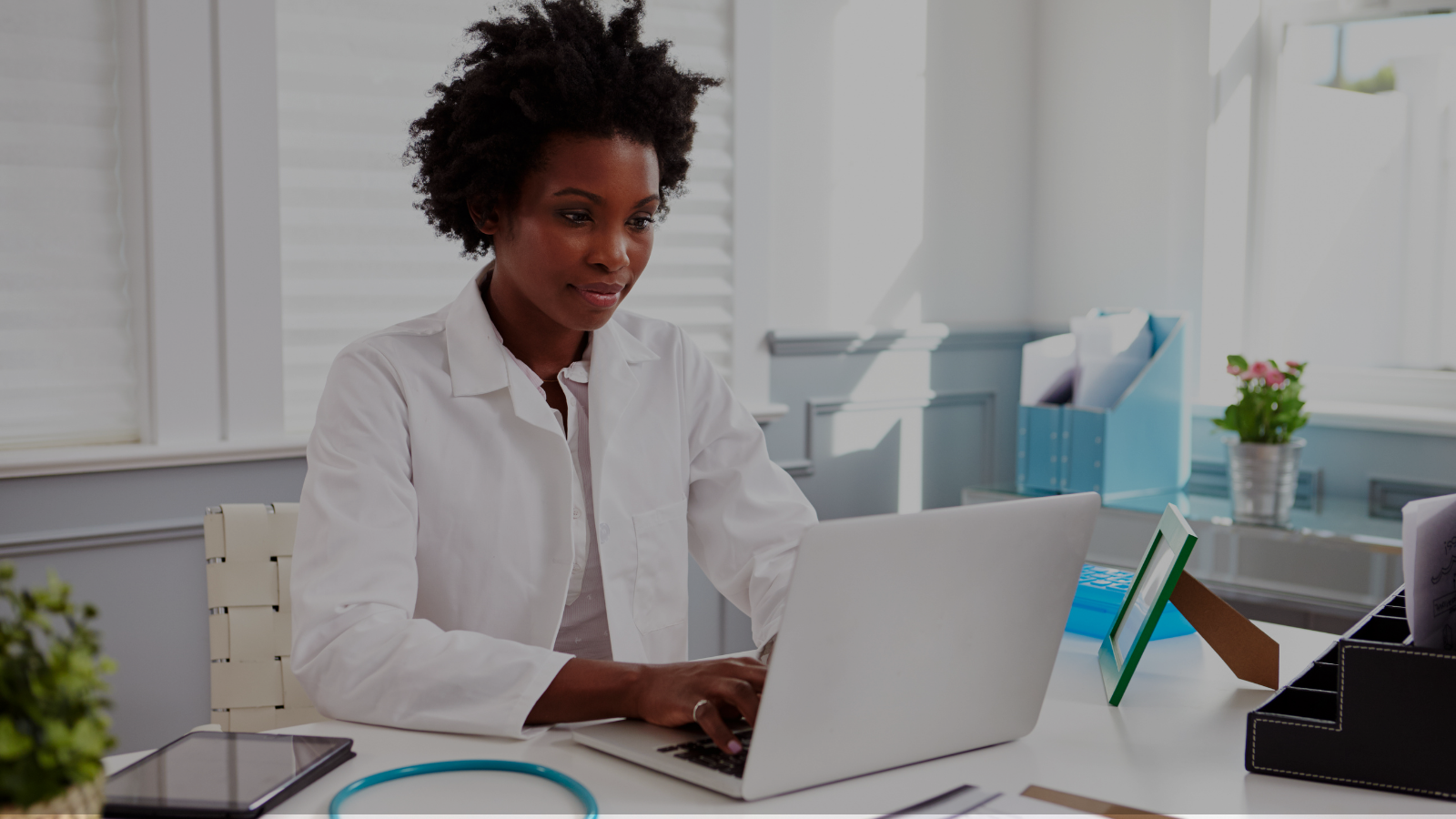 Image of female Black doctor on her computer