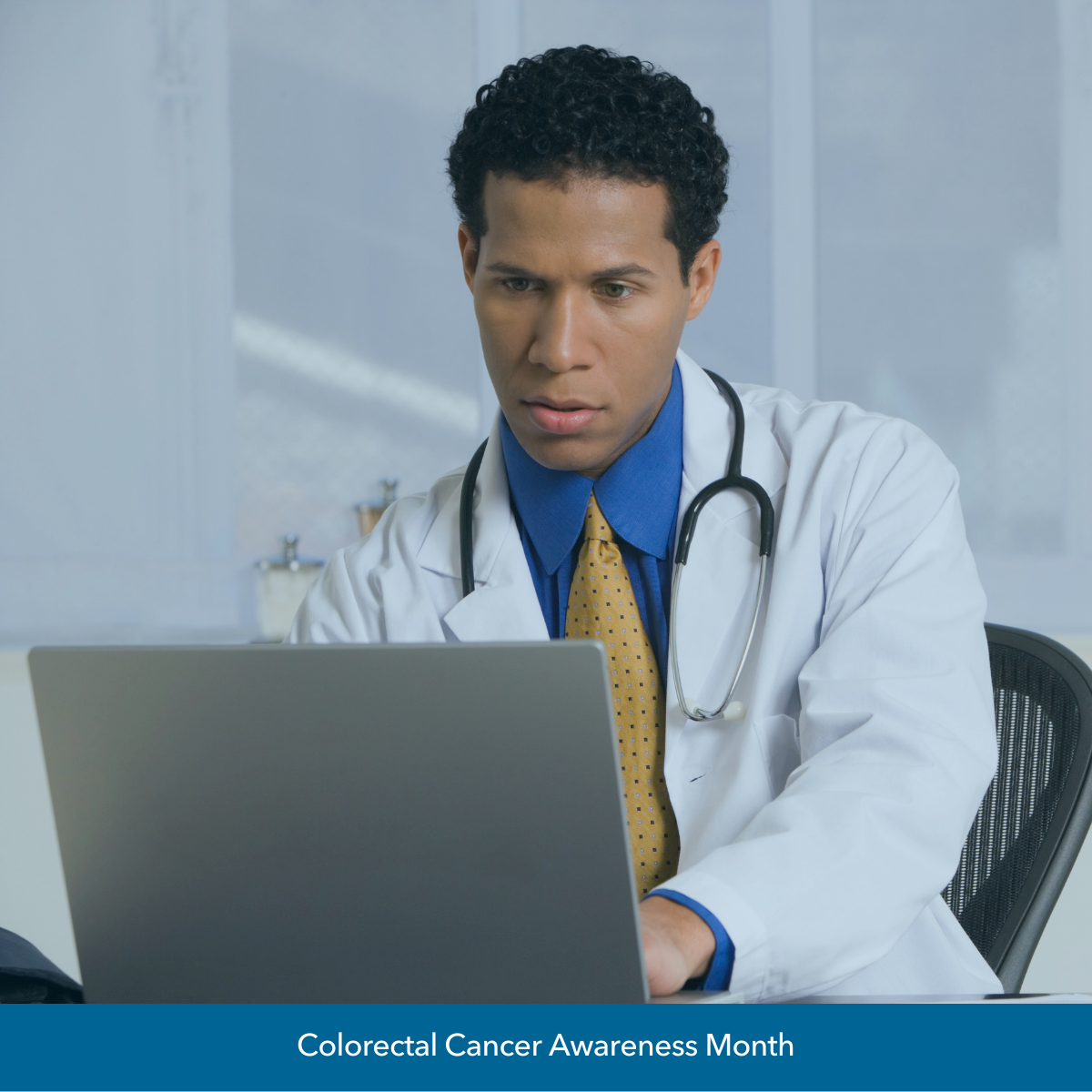 Image of Black male doctor working on computer