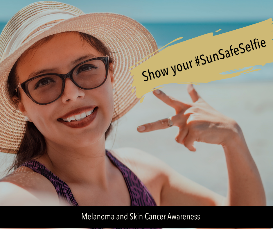 Image of woman taking a selfie at the beach. She's wearing sunglasses and a wide brim hat. Text reads: Share your #SunSafeSelfie
