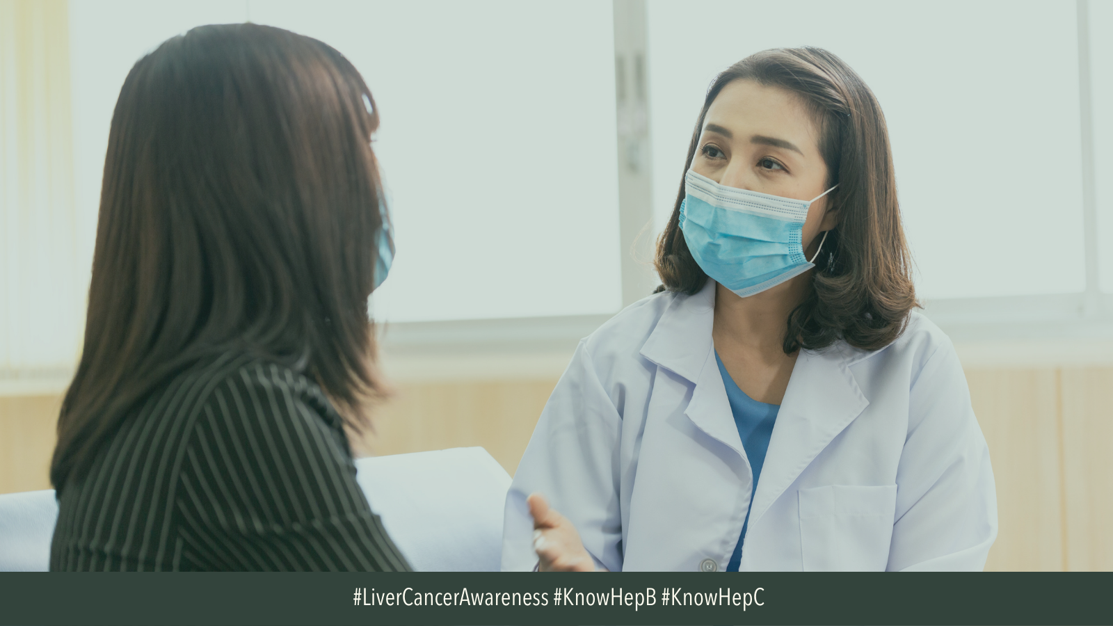 Image of Asian American female doctor speaking to patient with a mask on. 