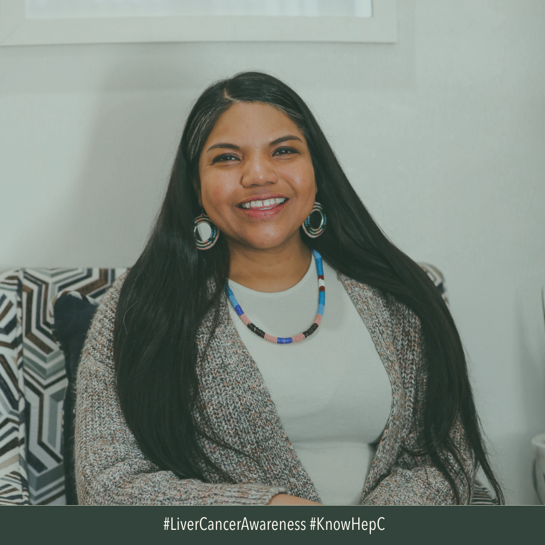 Image of American Indian woman smiling. She has long, dark hair, wearing jewelry, and smiling. 